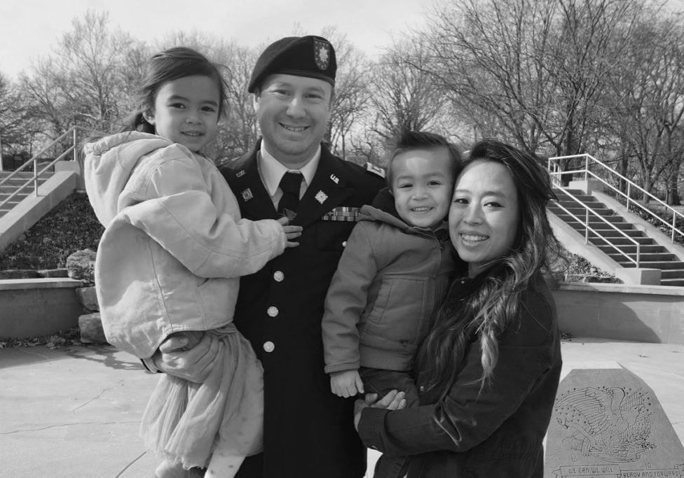 trang cline posing with her husband and two children