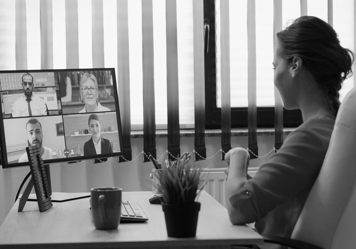 military spouse at desk participating in video conference